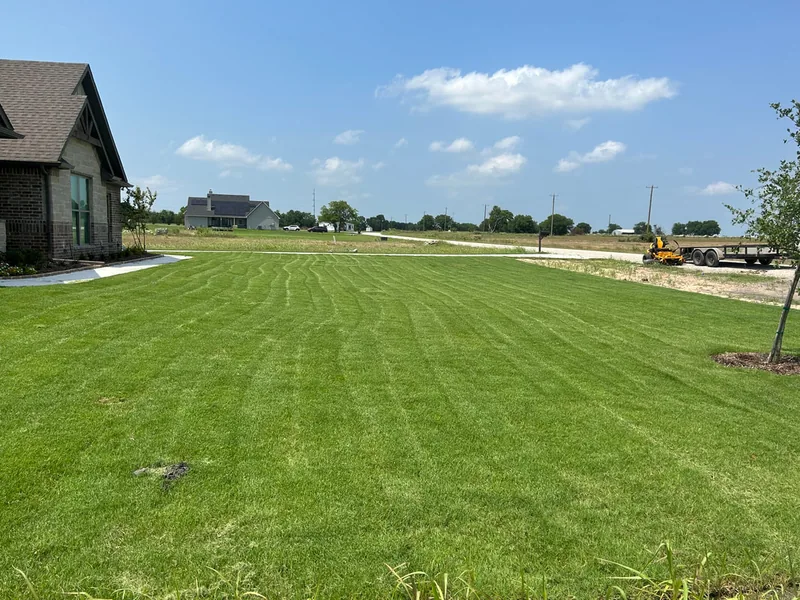 Rural North Texas property with crisp mow stripes and equipment trailer